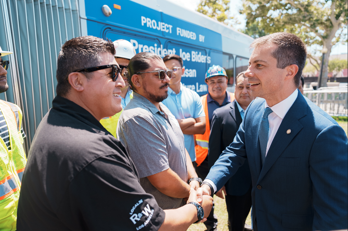 "Secretary Pete Buttigieg greeting Los Angeles union workers during event at Exposition Park, Los Angeles." 